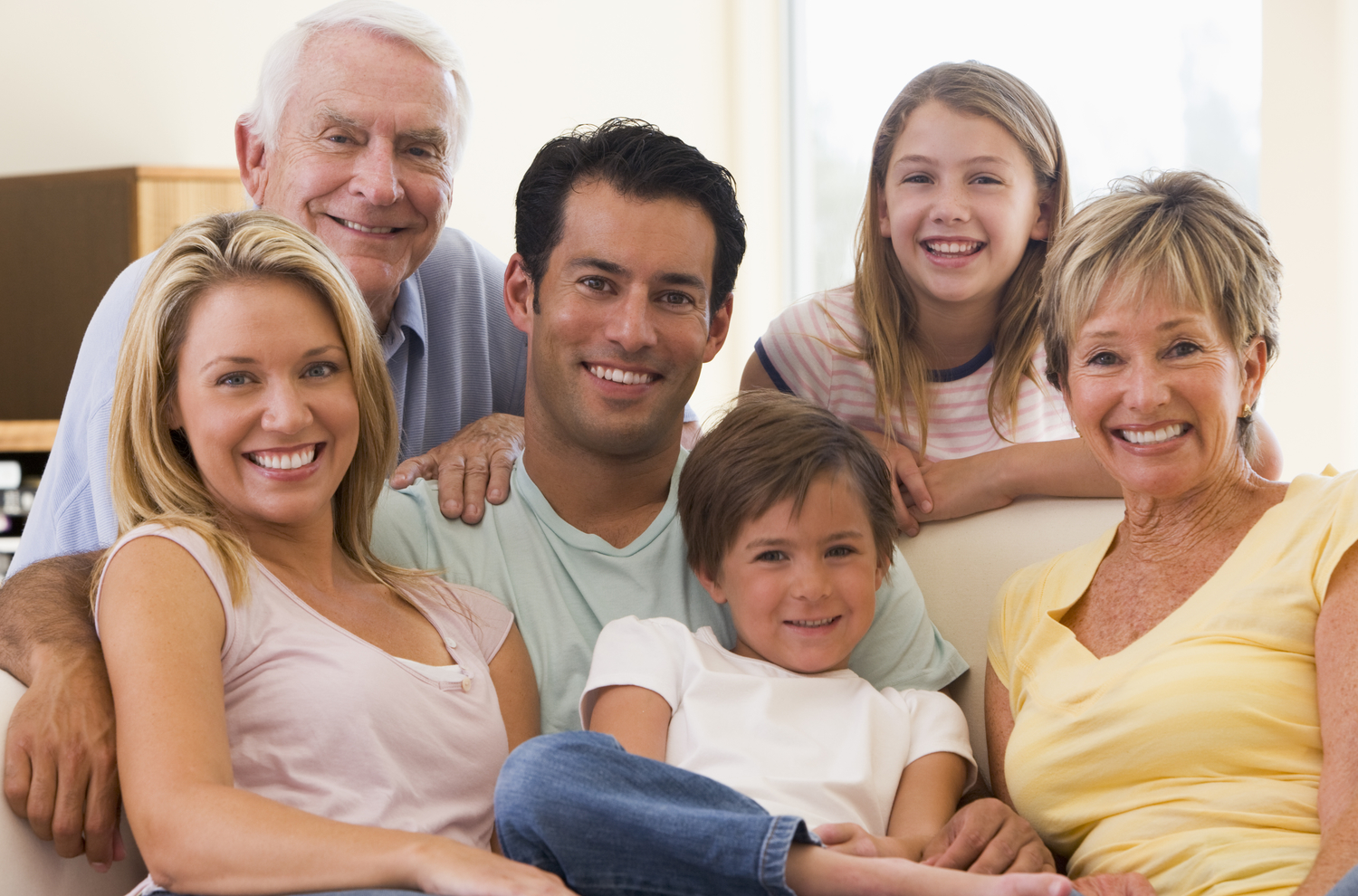 Extended family in living room smiling - Brainin Law Office